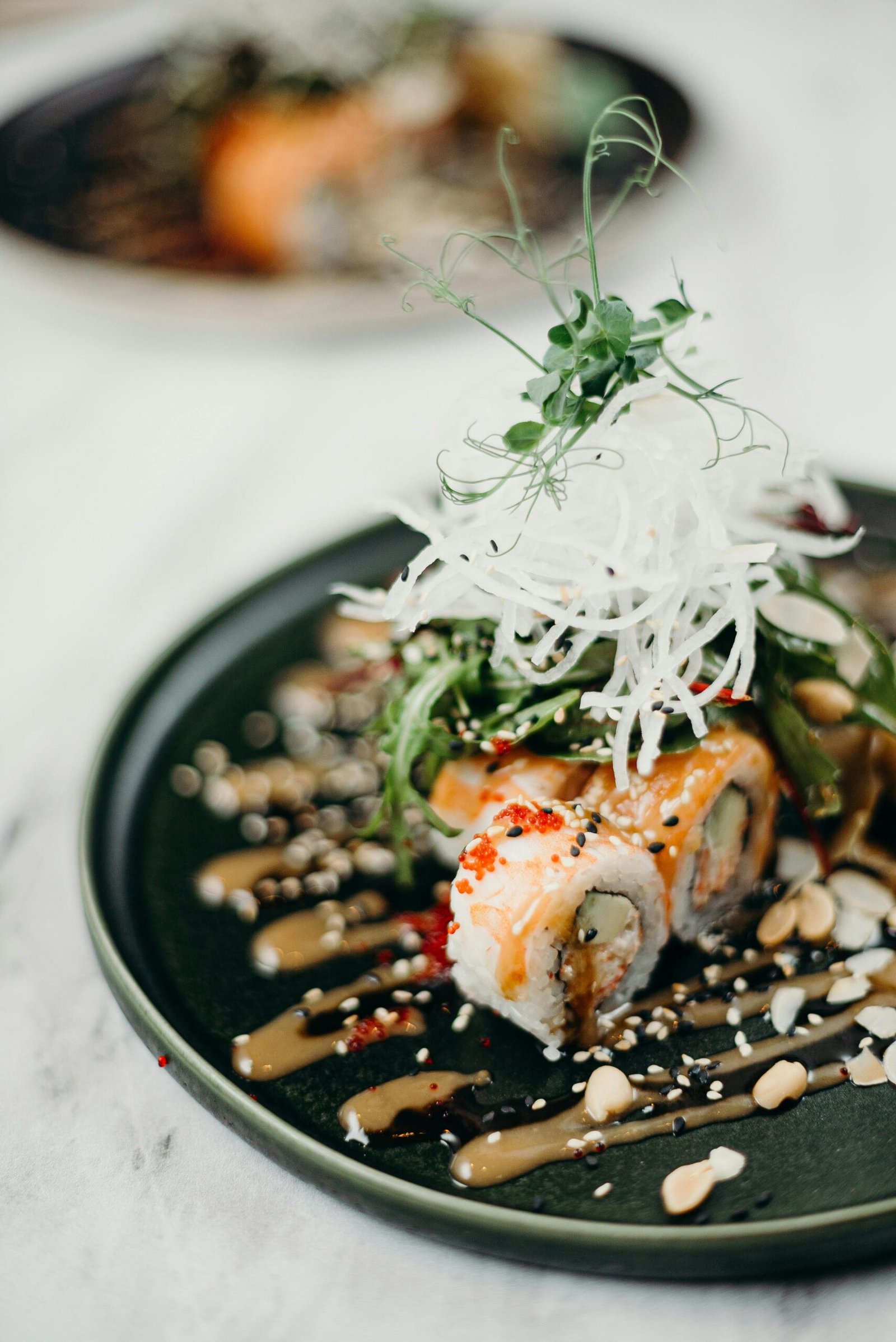 Home a plate of sushi with sauce and nuts in dragon birds regensburg